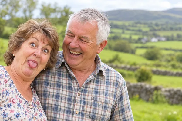 Irish couple over 60 having a laugh in the countryside